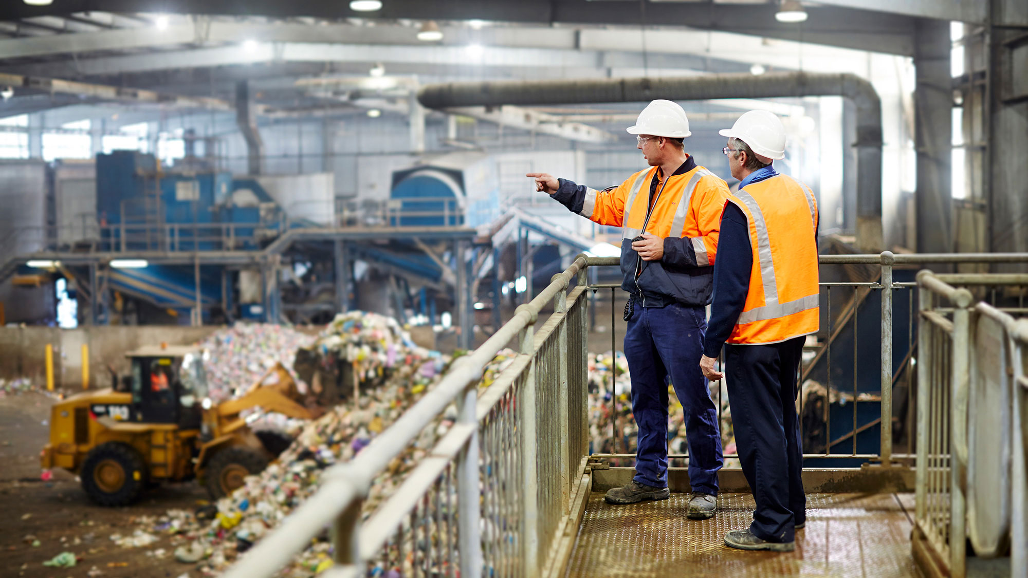 SUEZ managers overseeing recycling facility